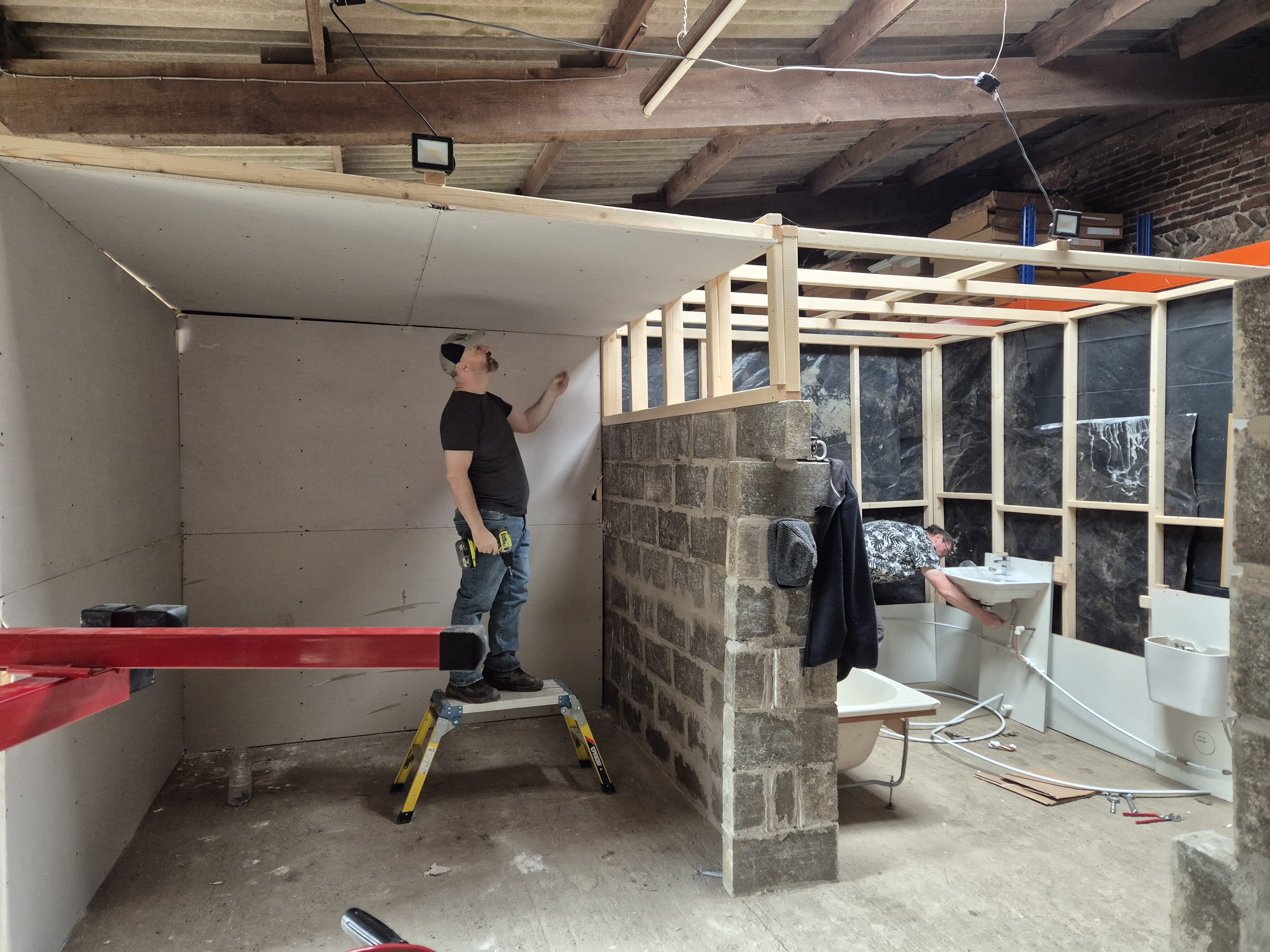 Learner applying plaster to a wall during live training